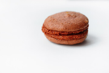Fototapeta na wymiar Brown chocolate macaroon cookie isolated on white background. French gluten free dessert