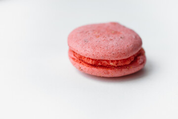 Pink macaroon raspberry cookie isolated on white background. French gluten free  dessert