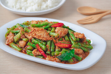 Stir fried pork with yard long bean and red curry paste served with rice, Thai food