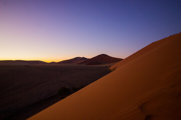 Fototapeta na wymiar Huge sand dune in desert at sunrise