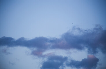 Fluffy clouds cover the summer blue sky