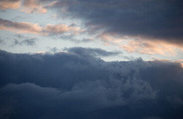 Fluffy clouds cover the summer blue sky