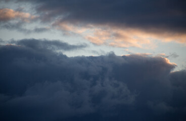 Fluffy clouds cover the summer blue sky