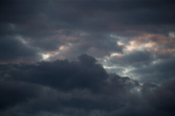 Fluffy clouds cover the summer blue sky
