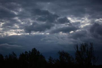 Fluffy clouds cover the summer blue sky