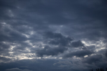 Fluffy clouds cover the summer blue sky