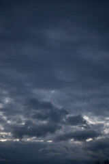 Fluffy clouds cover the summer blue sky