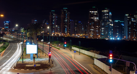 night city with streaks of light from headlights of cars