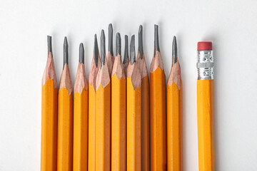 One pencil standing with eraser out from the group of other pencil. Concept of difference in social...
