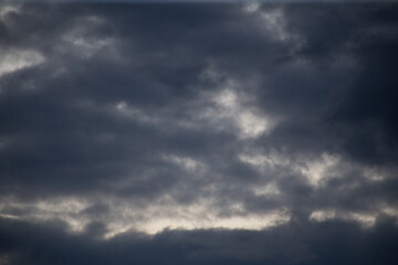 Fluffy clouds cover the summer blue sky