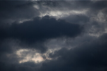 Fluffy clouds cover the summer blue sky