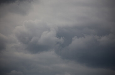 Fluffy clouds cover the summer blue sky