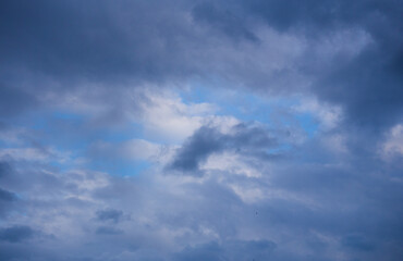 Fluffy clouds cover the summer blue sky