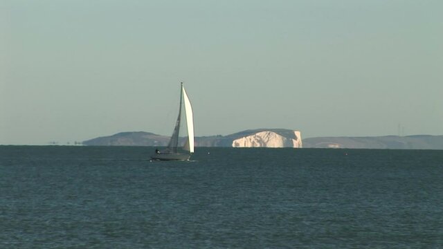 White cliffs of dover with sailing boat in foreground UK