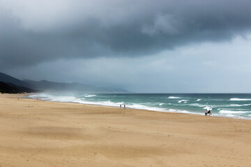 Fototapeta na wymiar Long deserted beach before storm