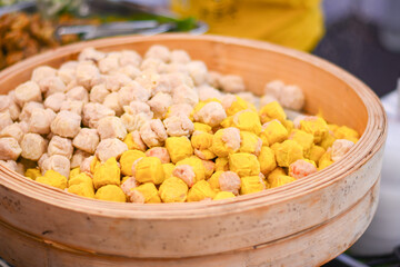 'Shumai' or 'Shaomai' a 'Dim Sum' Chinese traditional steamed dumplings food, Shumai is a type of traditional Chinese dumpling filled with shrimp pork or crab,Chinese dim sum in bamboo steam box