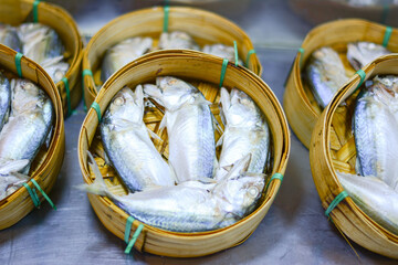 Bodied mackerels fishes in round basket made of bamboo, Popular fish in Mahachai market Samut Songkhram Thailand, Steamed mackerel fishes in bamboo basket for sale at the market