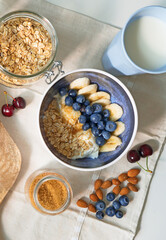 Healthy breakfast with berries, yogurt and oat flakes.