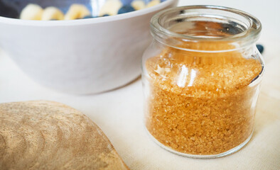 Brown sugar in the glass jar. Close-up view.
