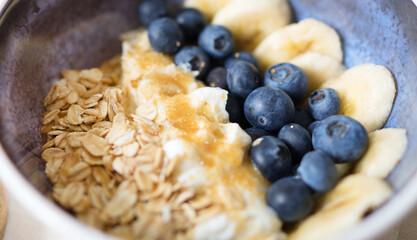 Healthy breakfast with berries, yogurt and oat flakes.