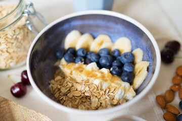 Healthy breakfast with berries, yogurt and oat flakes.
