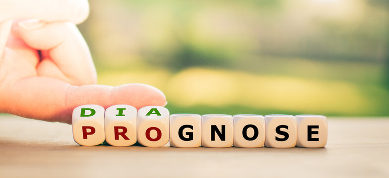 Hand turns dice and changes the word "prognose" to "diagnose".