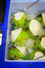 fresh coconut fruits Soak in Ice Bucket, Fresh green young coconuts for sale in the street market...
