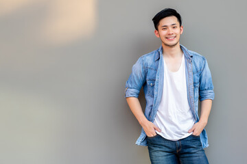 Portrait handsome asian man. Cool guy get happy time of life because he get lucky, success of business. Handsome man has nice smile. Attractive man wear jeans, t shirt, denim jacket. He look cool.  - Powered by Adobe