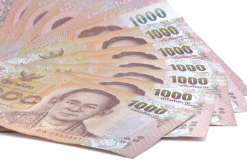 Close up shot of Thai 1000 BAHT banknotes cash money bill , on white background ,concept of economy finance savings investing spending expenses, Thai currency banknote of Thailand concepts,