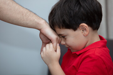 Little boy kiss his father's hand during Eid mubarak (Turkish Ramazan or Seker Bayram).