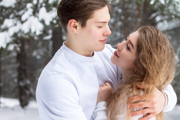 Fototapeta premium beautiful couple in love Valentine's day romance of love in winter in the snow