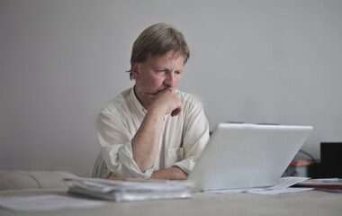 man works with a laptop at home