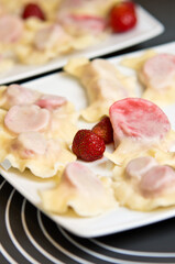 Plate of Polish strawberry dumplings in the kitchen.