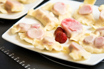 Plate of Polish strawberry dumplings in the kitchen.