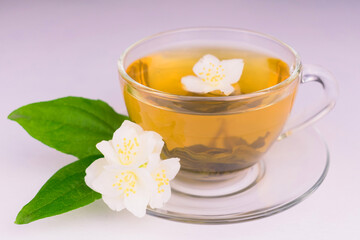 Cup of jasmine tea and jasmine flowers on a white background.Close-up