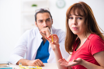 Female diabetic patient visiting young male doctor