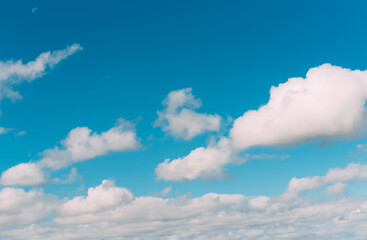 white clouds in a blue sky. Bright day, horizontal photography