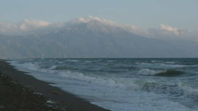 wavy sea and wind on a beach mountain background with clouds hatay samandag keldag turkey syria border