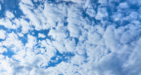 Fototapeta na wymiar Blue sky background with white clouds on a sunny day.