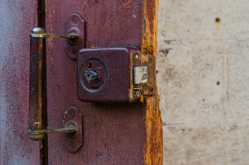 Fototapeta na wymiar Close-up, old lock on a red wooden door