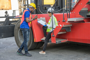 Fototapeta premium Engineer wearing a hardhat standing cargo at the container yard and Check container integrity Before exporting products abroad. Shipping import, export industrial concept.