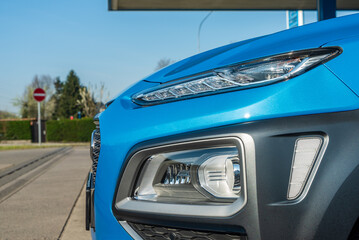 Side front of a blue car with a modern led headlights 