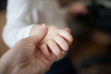 Baby holding mother hand tenderness of motherhood