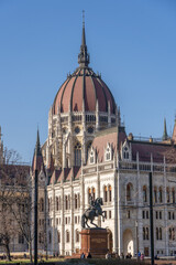 Budapest, Hungary - Feb 8, 2020: Parliament dome view with equestrian statue in Kossuth Square