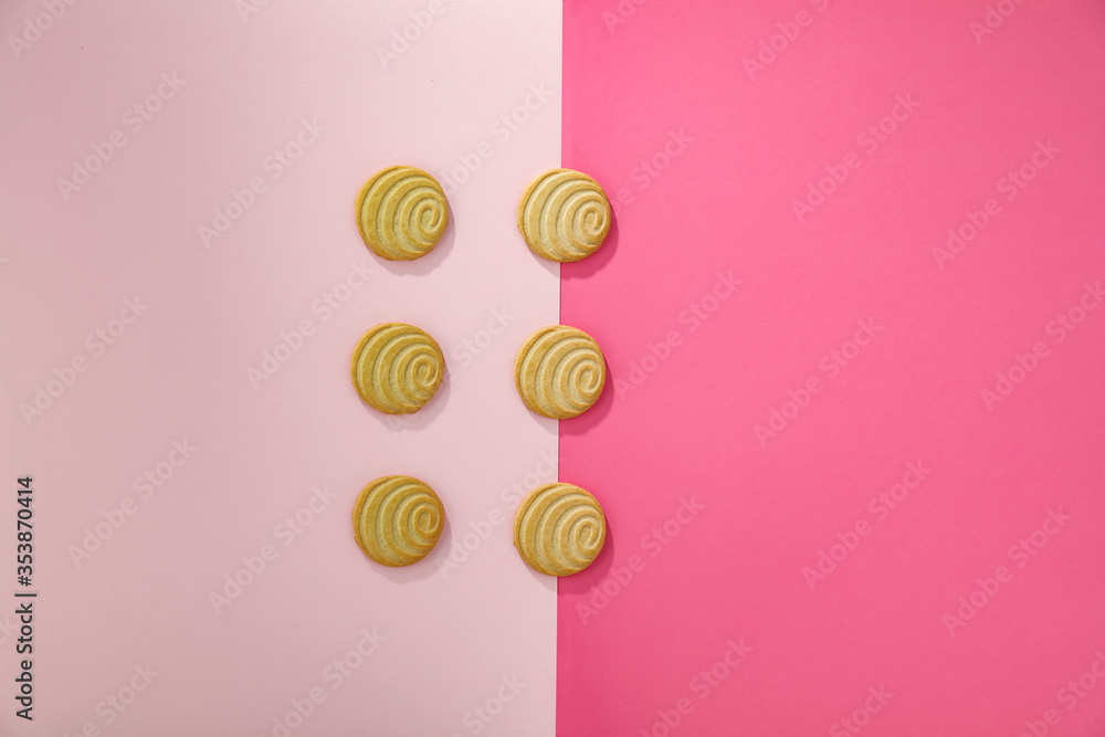 Wall mural Aerial butter cookies on a pink background