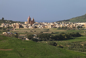 Fototapeta na wymiar A small village with a large domed church in the countryside on Gozo, Malta