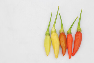 Green and red chilies with white background. Chillies, ingridient of Thai or asian food.