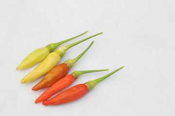 Green and red chilies with white background. Chillies, ingridient of Thai or asian food.