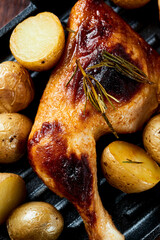 Crispy Baked Chicken Legs with potatoes. Top view. 
