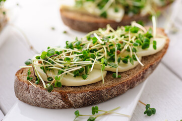 a sandwich with green young sprouts, micro greens and mozzarella, a healthy and healthy snack